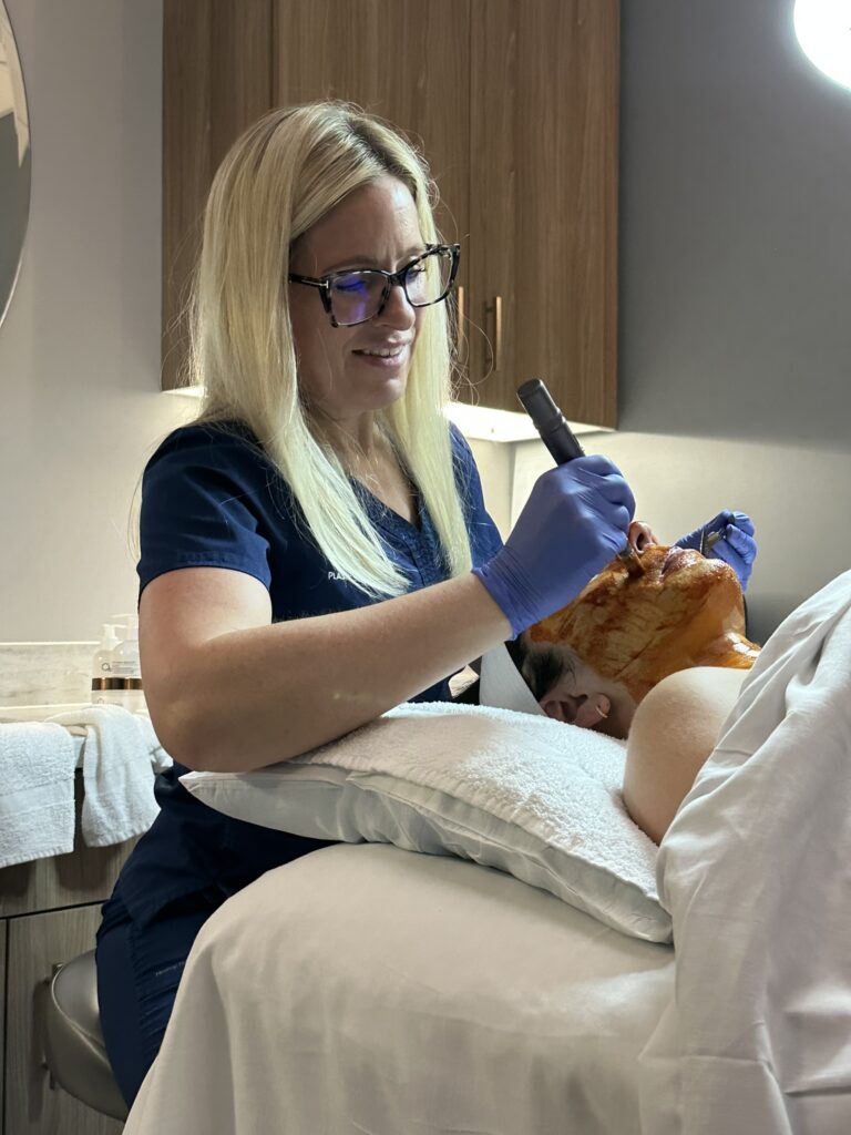 Kelly, aesthetician, performing an Osmosis facial on a patient. 